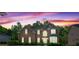 Red brick home at dusk with a colorful, cloud-filled sky at 1517 Granby Ln, Locust Grove, GA 30248