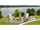 Outdoor stone fire pit with Adirondack chairs overlooking the lake, perfect for relaxing evenings at 1517 Granby Ln, Locust Grove, GA 30248