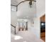 Bright foyer featuring soaring ceilings, beautiful hardwood floors, and a staircase leading to the second level at 1517 Granby Ln, Locust Grove, GA 30248