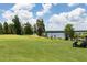 Picturesque golf course by the water, featuring lush green grass, golfers, and a golf cart at 1517 Granby Ln, Locust Grove, GA 30248