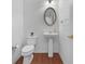 Clean powder room featuring a pedestal sink, toilet, and modern fixtures at 1517 Granby Ln, Locust Grove, GA 30248