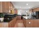 Well-equipped kitchen with wooden cabinets, stainless steel appliances, and black countertops at 1517 Granby Ln, Locust Grove, GA 30248