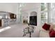Bright and open living room with fireplace, bar seating, and high ceilings at 1517 Granby Ln, Locust Grove, GA 30248
