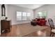 Comfortable living room featuring a cozy couch, stylish furniture, and bright windows at 1517 Granby Ln, Locust Grove, GA 30248