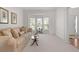 Cozy living room with carpeting, neutral furniture, and a bright bay window at 1517 Granby Ln, Locust Grove, GA 30248