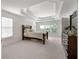 Bright main bedroom featuring a large bed, coffered ceilings, and an ample amount of natural light at 1517 Granby Ln, Locust Grove, GA 30248