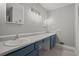Bathroom featuring double sinks, under sink cabinetry, and tile floors at 9 Buckhorn Dr, Temple, GA 30179