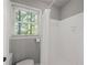 Bathroom featuring white tile shower and a window at 9 Buckhorn Dr, Temple, GA 30179