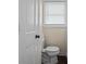 Standard bathroom with a toilet, window, and a view of the door at 9 Buckhorn Dr, Temple, GA 30179
