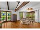 Dining room with hardwood floors, ceiling fan, beamed ceiling, and access to a deck at 9 Buckhorn Dr, Temple, GA 30179