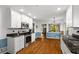 View of kitchen featuring stainless appliances, granite countertops, white cabinets and hardwood floors at 9 Buckhorn Dr, Temple, GA 30179