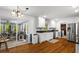 View of kitchen with stainless appliances, white cabinets, granite counters, and hardwood floors at 9 Buckhorn Dr, Temple, GA 30179