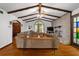 Living room featuring beamed ceiling, hardwood floors, and brick fireplace at 9 Buckhorn Dr, Temple, GA 30179