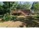 Spacious backyard features a tiered deck, brick home, and mature shade trees at 3207 Canary Ct, Decatur, GA 30032