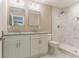 Stylish bathroom featuring a double sink vanity, white cabinets, granite countertops, and tiled shower at 3207 Canary Ct, Decatur, GA 30032