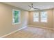 Bright bedroom features neutral walls, carpet flooring, updated ceiling fan, and multiple windows for natural light at 3207 Canary Ct, Decatur, GA 30032