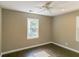 Bright bedroom with hardwood flooring, neutral walls, white trim, modern ceiling fan, and ample natural light at 3207 Canary Ct, Decatur, GA 30032