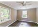 Charming bedroom with hardwood flooring, neutral walls, updated ceiling fan, white trim, and bright windows at 3207 Canary Ct, Decatur, GA 30032