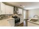 Renovated kitchen with white cabinets, granite countertops, and stainless steel appliances at 3207 Canary Ct, Decatur, GA 30032