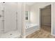 Bathroom featuring a tub and shower combination and a view to the walk-in closet at 486 Charleston Pl, Villa Rica, GA 30180
