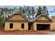Unfinished exterior view of a single-story home with a two-car garage and an unfinished yard at 486 Charleston Pl, Villa Rica, GA 30180