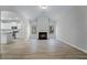 Spacious living room featuring a fireplace, hardwood floors, and open access to a modern kitchen at 486 Charleston Pl, Villa Rica, GA 30180