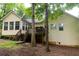 Back exterior of home features a deck and a lush, green yard at 1043 Foxhollow Trl, Canton, GA 30115