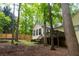 Backyard with a wood deck and tall trees for privacy at 1043 Foxhollow Trl, Canton, GA 30115