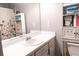 Well-lit bathroom with a vanity, sink, mirror, and ample storage space at 1043 Foxhollow Trl, Canton, GA 30115