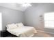 Cozy bedroom features a ceiling fan and a large window providing natural light at 1043 Foxhollow Trl, Canton, GA 30115