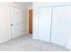 Bedroom featuring large closet and neutral carpeting at 1043 Foxhollow Trl, Canton, GA 30115