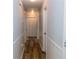 Bright hallway featuring neutral walls, modern trim, and stylish wood-look flooring at 1043 Foxhollow Trl, Canton, GA 30115