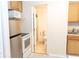 Efficient kitchen with stainless steel refrigerator and access to bathroom at 1043 Foxhollow Trl, Canton, GA 30115
