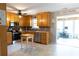 Well-lit kitchen with stainless steel appliances, wood cabinets, and tiled floor at 1043 Foxhollow Trl, Canton, GA 30115