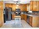 Well-lit kitchen with stainless steel appliances, wood cabinets, and tiled floor at 1043 Foxhollow Trl, Canton, GA 30115