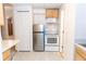 Compact kitchen featuring white appliances and tile flooring at 1043 Foxhollow Trl, Canton, GA 30115