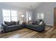 Bright living room with vaulted ceilings, wood floors, and comfortable seating at 1043 Foxhollow Trl, Canton, GA 30115