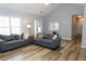 Bright living room with vaulted ceilings, wood floors, and comfortable seating at 1043 Foxhollow Trl, Canton, GA 30115