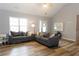 Bright living room with vaulted ceilings, wood floors, and comfortable seating at 1043 Foxhollow Trl, Canton, GA 30115