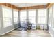 Light-filled sunroom with wood floors and ample windows at 1043 Foxhollow Trl, Canton, GA 30115