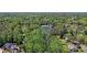 An aerial shot of a green, lush forest with a small lake at the center and scattered houses around it at 1610 Glenhurst Dr, Snellville, GA 30078