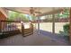 Tiled outdoor back porch with steps down to a hot tub and backyard at 1610 Glenhurst Dr, Snellville, GA 30078