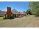 Back of house with yard, deck and trees at 1610 Glenhurst Dr, Snellville, GA 30078