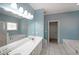 Bright bathroom with double vanity, separate shower, and whirlpool tub at 1610 Glenhurst Dr, Snellville, GA 30078
