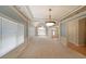 Spacious dining area with large windows, decorative trim, and views into the entry and living spaces at 1610 Glenhurst Dr, Snellville, GA 30078