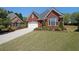 Beautiful brick home with a manicured lawn and attractive landscaping in a quiet neighborhood setting at 1610 Glenhurst Dr, Snellville, GA 30078