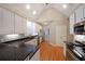 Bright kitchen features stainless appliances, granite counters, white cabinets, and hardwood floors at 1610 Glenhurst Dr, Snellville, GA 30078