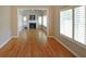 Cozy living room with a fireplace, hardwood floors, plantation shutters, and a vaulted ceiling at 1610 Glenhurst Dr, Snellville, GA 30078