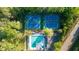 An aerial view of community amenities including a pool, tennis courts, and surrounding greenery, promoting an active lifestyle at 2441 Mitchell Ne Rd, Marietta, GA 30062
