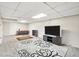 Finished basement with tiled floors, entertainment center, and a rug, perfect for relaxation at 2441 Mitchell Ne Rd, Marietta, GA 30062